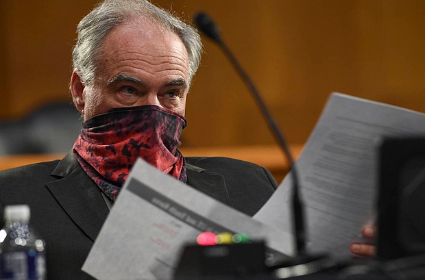 In this May 2020 photo, U.S. Sen. Tim Kaine wears a mask as he listens to testimony during a hearing before the Senate Committee for Health, Education, Labor and Pensions on Capitol Hill in Washington. Sen. Kaine, who has nerve tingling since contracting COVID-19 two years ago, recently introduced legislation to raise awareness of long COVID and treatment possibilities.