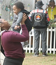 Five-month-old Royal Smith giggles as his grandmother, Deanna Casey, lifts him high at Arts in the Park at The Carillon in Byrd Park. The infant enjoyed the stroll to look at artwork with his grandmother and mother, D’Asia Hill. Thousands of people flocked to the festival that returned after a two-year hiatus because of the pandemic.