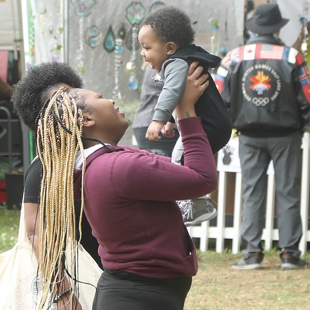 Five-month-old Royal Smith giggles as his grandmother, Deanna Casey, lifts him high at Arts in the Park at The Carillon in Byrd Park. The infant enjoyed the stroll to look at artwork with his grandmother and mother, D’Asia Hill. Thousands of people flocked to the festival that returned after a two-year hiatus because of the pandemic.