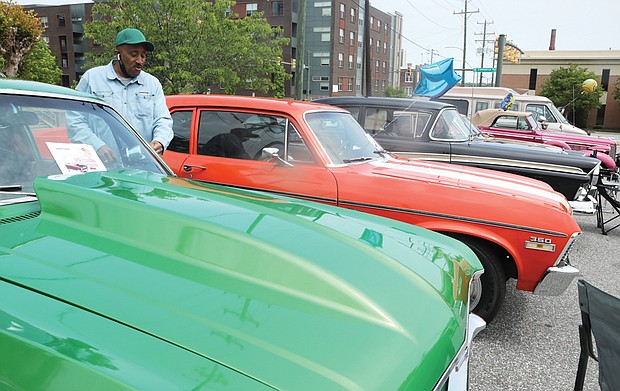 Jerry Wyatt, 64, of Mechanicsville proudly stands beside his shiny green 1969 Chevrolet Nova, just one of the classic cars that filled the parking lot Saturday at the Richmond Heritage Federal Credit Union, 50 W. Commerce Road in South Side. The show and sale of the restored cars celebrated the 86th birthday of the financial institution that Black Richmond teachers and Virginia Union University professors organized in 1936 during the Great Depression as a self- help organization. Long based in Jackson Ward, the member-owned credit union purchased this site in South Richmond in 2000 for its headquarters.