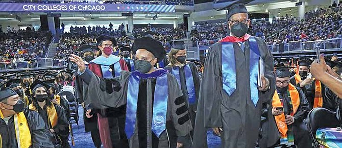Photo caption: Mayor Lightfoot and City Colleges of Chicago Board Trustee Darrell Williams join City Colleges of Chicago graduation procession
for the first in-person graduation in two years.
