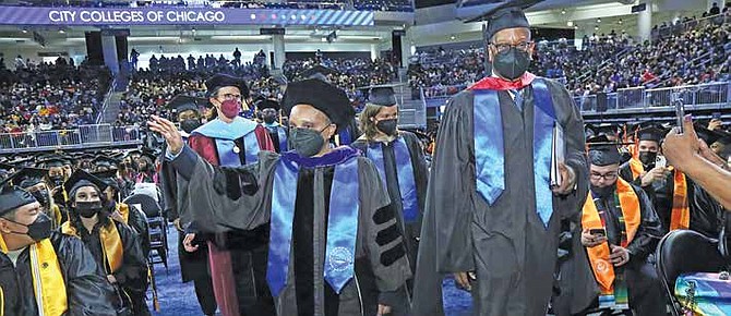 Photo caption: Mayor Lightfoot and City Colleges of Chicago Board Trustee Darrell Williams join City Colleges of Chicago graduation procession
for the first in-person graduation in two years.