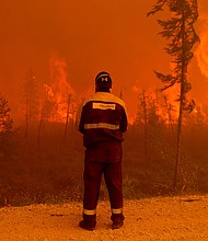 A forest fire near Kyuyorelyakh village at Gorny Ulus in Russia, in August 2021.
Mandatory Credit:	Ivan Nikiforov/AP