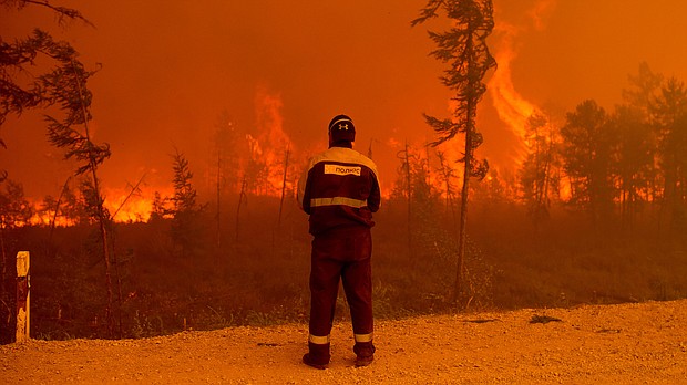 A forest fire near Kyuyorelyakh village at Gorny Ulus in Russia, in August 2021.
Mandatory Credit:	Ivan Nikiforov/AP