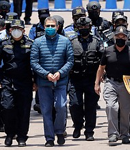 Hernández is escorted by members of the police special forces in Tegucigalpa ahead of his extradition.
Mandatory Credit:	Jorge Cabrera/Getty Images