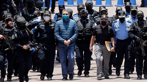 Hernández is escorted by members of the police special forces in Tegucigalpa ahead of his extradition.
Mandatory Credit:	Jorge Cabrera/Getty Images