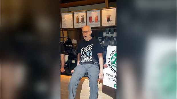 In protest of Starbucks charging more for vegan milk alternatives, Succession actor James Cromwell superglued his hand to a starbucks counter.
Mandatory Credit:	PETA