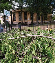 Downed tree limbs are piled along Main Street behind the Main Library in Downtown after brisk winds and heavy rain pummeled the city May 6. Friday Cheers and other outdoor events were canceled, and some schools closed early after the U.S. Weather Service included Richmond in a tornado watch. No twisters developed, but more than an inch of rain soaked the area during the storm.