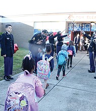 Students from Fox Elementary are welcomed Monday to their latest home at Clark Springs Elementary School in Randolph by cadets from Franklin Military Academy and their sword arch. Music, balloons, banners and city and school officials greeted the youngsters with high-fives and “good morning” wishes as they entered.