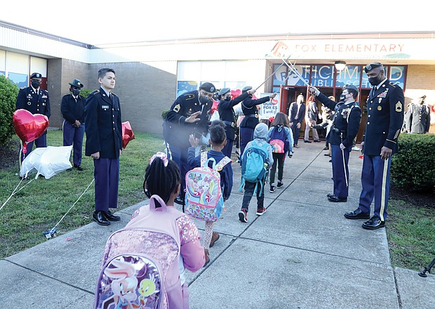 Students from Fox Elementary are welcomed Monday to their latest home at Clark Springs Elementary School in Randolph by cadets from Franklin Military Academy and their sword arch. Music, balloons, banners and city and school officials greeted the youngsters with high-fives and “good morning” wishes as they entered.