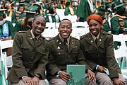 Newly commissioned Army ROTC officers, from left, Desiree Alford, Willie Bright and Monteau Jones smile during Norfolk State University’s commencement last Saturday at Echols Memorial Hall Arena.