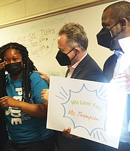Kiara S. Thompson, an eighth-grade physical science teacher at Boushall Middle School, breaks into tears as she is surprised May 6 in her classroom by Superintendent Jason Kamras, second from right, and Mayor Levar M. Stoney, with their announcement that she was selected Richmond’s Teacher of the Year.