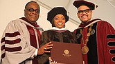 Social activist Tamika D. Mallory, who delivered the commencement address, smiles after receiving an honorary degree. She is flanked by Dr. W. Franklyn Richardson, left, chairman of the VUU Board of Trustees, and VUU President Hakim J. Lucas.