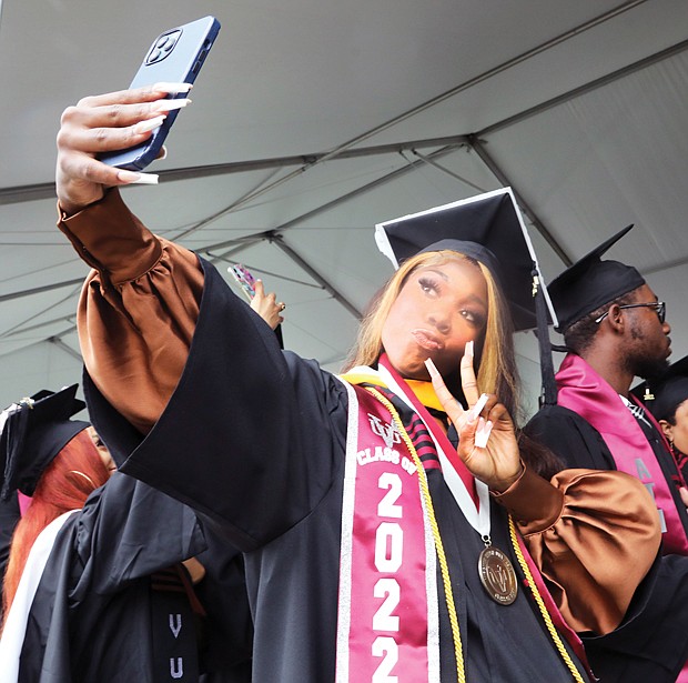 Tyonna Parker of Washington, D.C., a chemistry major who also minored in mathematics, takes a quick selfie during the ceremony. VUU President Hakim J. Lucas asked students to pause and take a selfie and tag themselves on social media.