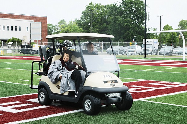 Dr. Lucille M. Brown, an Armstrong High School graduate, 1950 graduate of VUU, member of the VUU Board of Trustees and former superintendent of Richmond Public Schools, is give a motorized escort by campus police to the commencement exercises at Hovey Stadium.
