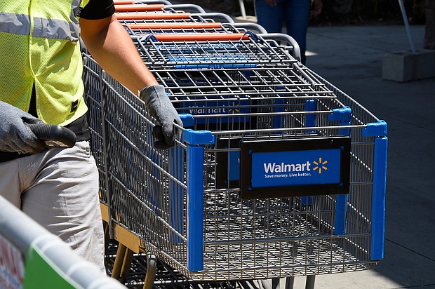 An employee gathers shopping carts at Walmart in July 2020 in Burbank, California. Walmart is creating a new program to fast-track recent college graduates into store manager positions.
Mandatory Credit:	Robyn Beck/AFP/Getty Images