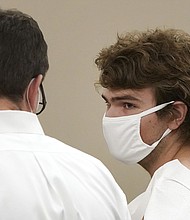 Authorities say the suspect Payton Gendron, pictured here during his arraignment in Buffalo City Court, who fatally shot 10 people and injured three others at a Buffalo supermarket in the heart of the city's Black community traveled from another New York county hours away.
Mandatory Credit:	Mark Mulville/AP