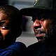 Wayne Jones holds his son Donell, while speaking during an interview with The Associated Press about his mother Celestine Chaney, who was killed in Saturday's shooting at a supermarket, in Buffalo, N.Y.  (AP photo)