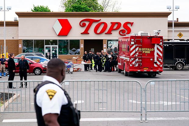 Investigators work the scene of a shooting at a supermarket in Buffalo on Monday, May 16, as social media posts by the 18-year-old White man suspected of shooting and killing 10 people at a Buffalo supermarket Saturday reveal he had been planning his attack for months.
Mandatory Credit:	Matt Rourke/AP