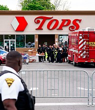 Investigators work the scene of a shooting at a supermarket in Buffalo on Monday, May 16, as social media posts by the 18-year-old White man suspected of shooting and killing 10 people at a Buffalo supermarket Saturday reveal he had been planning his attack for months.
Mandatory Credit:	Matt Rourke/AP