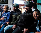 Wayne Jones, center left, accompanied by his aunt, JoAnn Daniels, center right, son Donell Jones, left, and daughter Kayla Jones, talks Monday during an interview about his mother, Celestine Chaney, who was killed at the shooting at a supermarket over the weekend in Buffalo, N.Y.