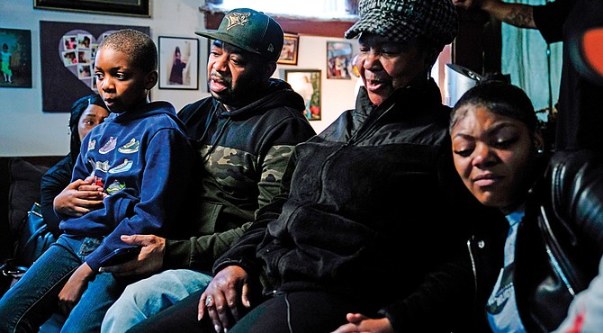 Wayne Jones, center left, accompanied by his aunt, JoAnn Daniels, center right, son Donell Jones, left, and daughter Kayla Jones, talks Monday during an interview about his mother, Celestine Chaney, who was killed at the shooting at a supermarket over the weekend in Buffalo, N.Y.