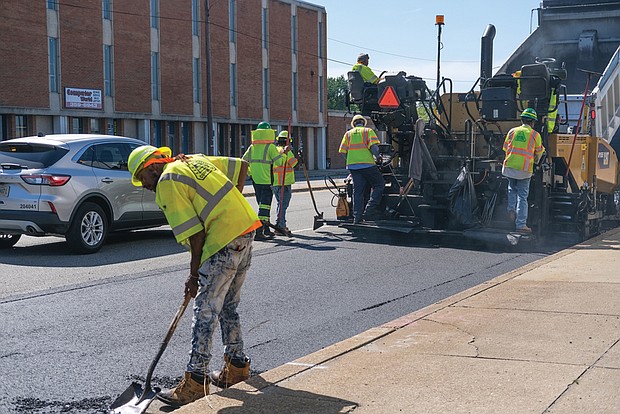 Richmond city workers lay asphalt across the pavement in the 4600 block of West Broad Street last Saturday. The re-pavement is one part of the City of Richmond’s Streetscape project, which began in April and is estimated to be completed by the fall of 2023. Planned changes include improved sidewalk accessibility for wheelchair users, those with visual impairments and others, new greenery and street furniture and other additions and constructions aimed at pedestrian and traffic safety.