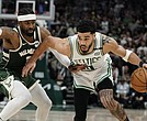 Boston Celtics Jayson Tatum tries to get past Milwaukee Buck Wesley Matthews during the second half of Game 6 of an NBA basketball Eastern Conference semifinals playoff series on May 13 in Milwaukee.