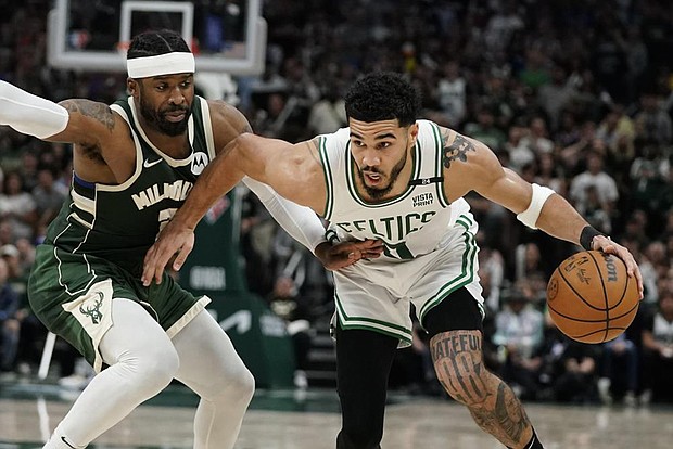 Boston Celtics Jayson Tatum tries to get past Milwaukee Buck Wesley Matthews during the second half of Game 6 of an NBA basketball Eastern Conference semifinals playoff series on May 13 in Milwaukee.