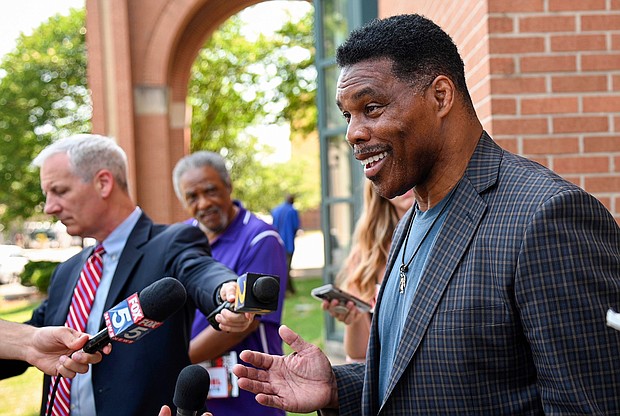 Republican Senate candidate Herschel Walker speaks with reporters after a campaign rally at the Georgia Sports Hall of Fame in Macon on May 18.
Mandatory Credit:	Jason Vorhees/AP