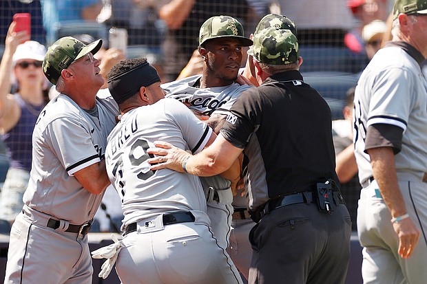 Tim Anderson is restrained by teammate José Abreu during Saturday's game in New York.
Mandatory Credit:	Sarah Stier/Getty Images