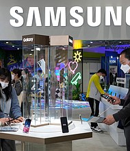 Samsung outlined a plan to pour more than $350 billion into its businesses and create tens of thousands of new jobs over the next five years.
Mandatory Credit:	Ahn Young-joon/AP