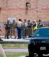 Law enforcement, and other first responders, gather outside Robb Elementary School following a shooting on May 24 in Uvalde, Texas.
Mandatory Credit:	Dario Lopez-Mills/AP