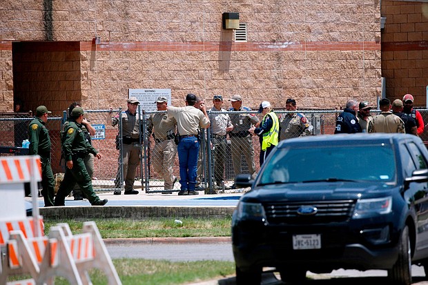 Law enforcement, and other first responders, gather outside Robb Elementary School following a shooting on May 24 in Uvalde, Texas.
Mandatory Credit: Dario Lopez-Mills/AP