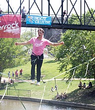 Davis Hermes performs on a slackline for Riverrock attendees on Sunday afternoon. He is a member of the Trickline Collective, a group of slackliner professionals who travel the world to deliver slackline entertainment.