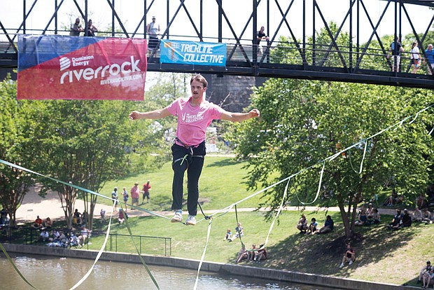 Davis Hermes performs on a slackline for Riverrock attendees on Sunday afternoon. He is a member of the Trickline Collective, a group of slackliner professionals who travel the world to deliver slackline entertainment.