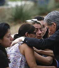 The archbishop of San Antonio, Gustavo Garcia-Siller, comforts families outside the Civic Center following a deadly school shooting at Robb Elementary School in Uvalde, Texas, on Tuesday.