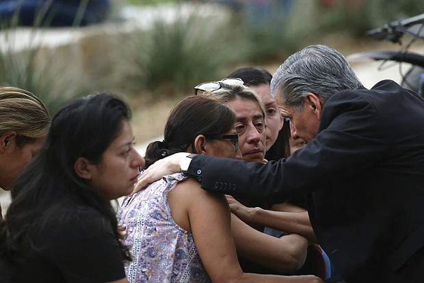 The archbishop of San Antonio, Gustavo Garcia-Siller, comforts families outside the Civic Center following a deadly school shooting at Robb Elementary School in Uvalde, Texas, on Tuesday.