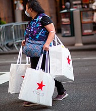 Affluent shoppers are splurging on new outfits at Macy's, Nordstrom and other high-end outlets, while lower-income customers are pulling back on discretionary items, leading retailers say.
Mandatory Credit:	KENA BETANCUR/AFP/Getty Images