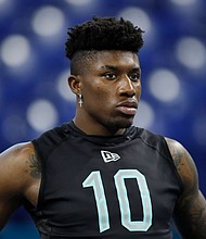 Jeff Gladney watches the 40-yard dash at the NFL football scouting combine in Indianapolis on March 1, 2020.
Mandatory Credit:	Charlie Neibergall/AP