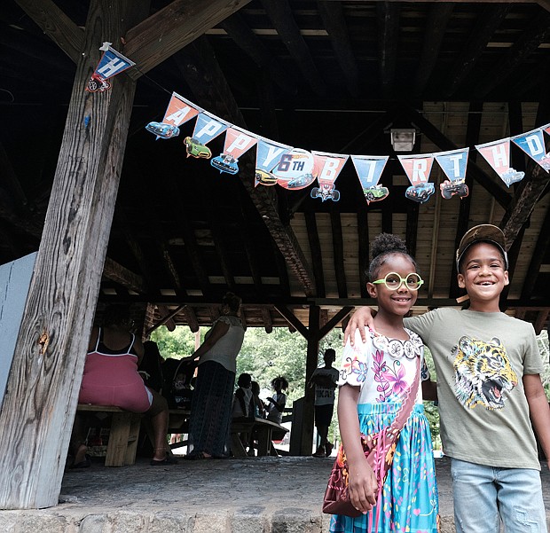 Cousins Serenity Epps, 7 left, and Amir Sanchez, 6, celebrate their birthdays during a family celebration in Forest Hill Park during the Memorial Day weekend.