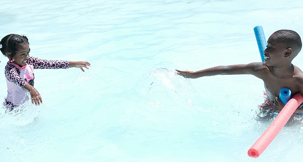 Xuri Griffn Williams, 2, and her 8-year-old brother Kamari Stone cool off in the Blackwell Community Pool in South Side on Memorial Day weekend. The Blackwell Pool was one of four city pools open for the holiday.