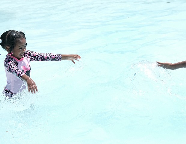 Xuri Griffn Williams, 2, and her 8-year-old brother Kamari Stone cool off in the Blackwell Community Pool in South Side on Memorial Day weekend. The Blackwell Pool was one of four city pools open for the holiday.
