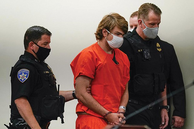 Payton Gendron is led into the courtroom for a hearing May 19 at Erie County Court in Buffalo, N.Y. He faces charges in the May 14 fatal shooting at a Buffalo supermarket.