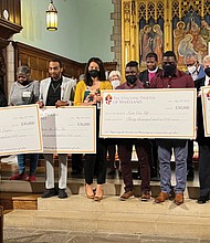 Bishop Eugene Taylor Sutton, rear, offers a blessing over the work of the inaugural Diocese of Maryland reparations grants awardees on May 26.