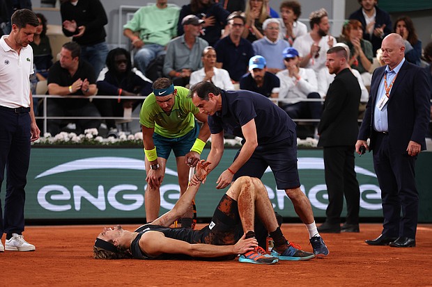 Alexander Zverev of Germany receives medical attention as Rafael Nadal of Spain looks on Friday in the men's semifinal match at the French Open.
Mandatory Credit:	Clive Brunskill/Getty Images