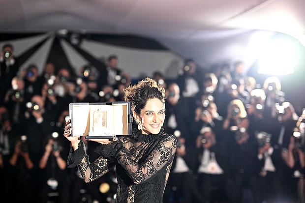 Iranian actress Zar Amir Ebrahimi poses with her trophy during a photocall after she won the best actress prize for her part in "Holy Spider" at the Cannes Film Festival in France, on May 28.
Mandatory Credit:	Loic Venance/AFP/Getty Images