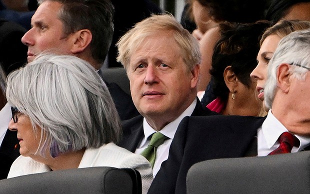 Britain's Prime Minister Boris Johnson reacts during Queen Elizabeth's Platinum Party, at Buckingham Palace, in London, Britain, June 4.
Mandatory Credit:	Paul Ellis/Pool/Reuters