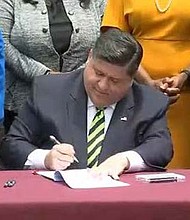 Gov. JB Pritzker signs legislation providing $700 million in new annual funding for nursing homes to improve staffing levels and quality of care. (Credit: Blueroomstream.com)