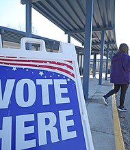 A person walks past a sign during a runoff election for Louisiana governor at a polling station at Quitman High School on November 16, 2019 in Quitman, Louisiana.
Mandatory Credit:	Matt Sullivan/Getty Images